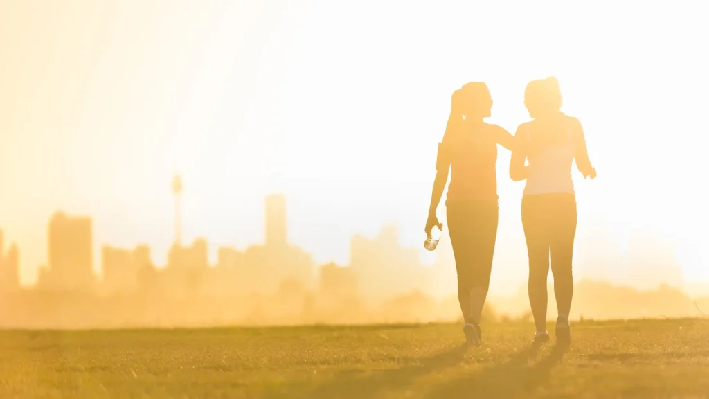 Queer people walking with sunrise and nyc in the skyline